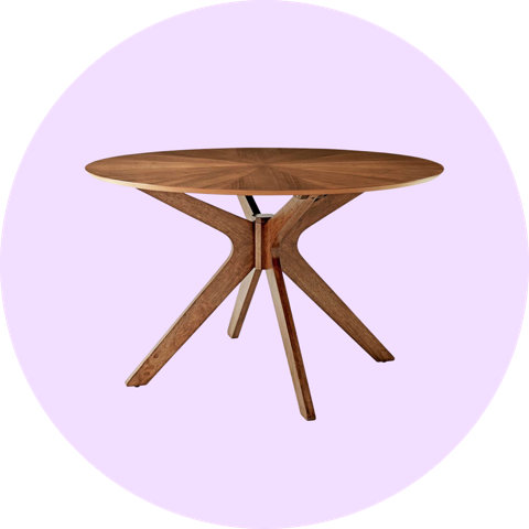 Round wooden dining table with a starburst pattern top and cross-leg base on a light purple circular background.