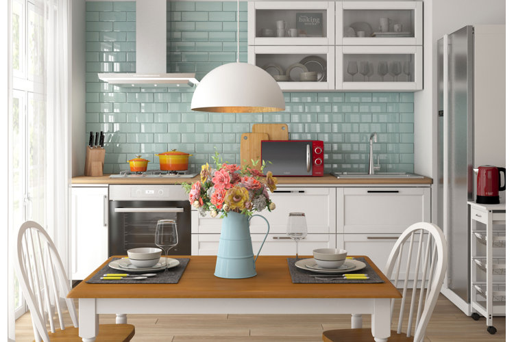 modern cottage kitchen with a light teal backsplash, wooden dining table, and a floral arrangement in a blue pitcher