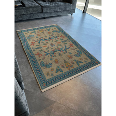 Tapis décoratif bleu et beige à motif de libellules et de papillons