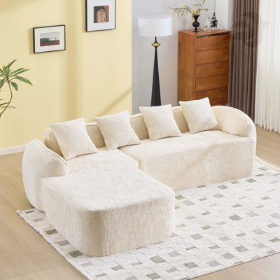 Beige chenille L-shaped compressed sofa that goes well with any living room. It features high-elastic sponge for a comfortable sitting feel,  curved armrests and four throw pillows.