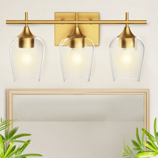 2 lumières de salle de bain dorées au-dessus d'un miroir