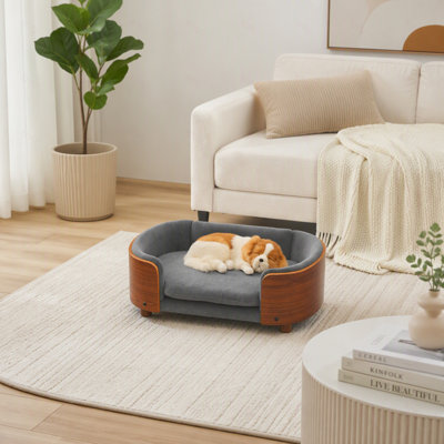 Lit pour chien surélevé de style scandinave avec pattes en bois massif et dossier en bois courbé, coussin en velours