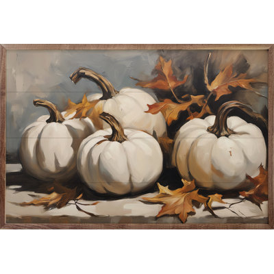 Quatre citrouilles blanches avec des feuilles
