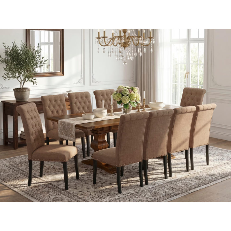 L'ensemble de salle à manger 11 pièces comprend une table rectangulaire avec rallonge amovible et 10 chaises rembourrées en tissu de lin sable clair, noyer