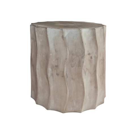 Concrete drum side table with a fluted, wavy textured exterior in a neutral gray finish.