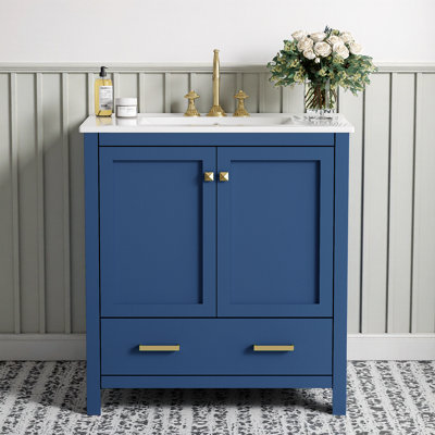 Meuble-lavabo bleu avec lavabo encastré, portes à fermeture douce et armoire de rangement