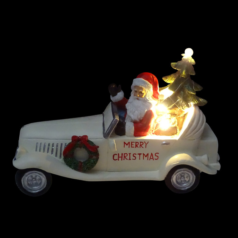 Statue de joyeux Noël père Noël dans une voiture blanche rétro avec DEL