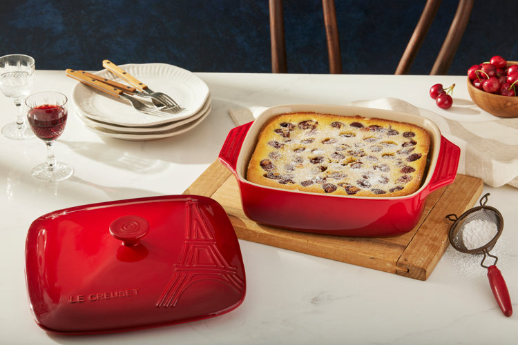 dinner table with a red casserole dish with a homemade pie inside