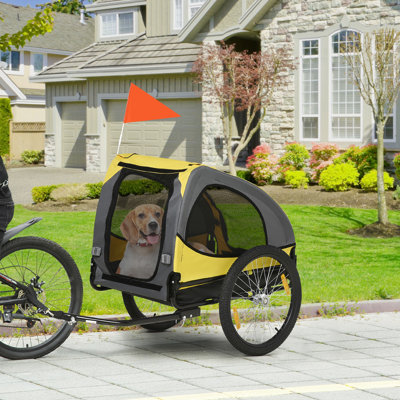 Chariot de voyage moyen pour chien - Remorque pour animal de compagnie. Fabrication en acier, filet de ventilation. Drapeau pour. Remorque de transporteur jaune, construction, confort et balisage