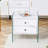 Double-Drawer Bedside Table.The Board Surface Is MDF With White Grain Sticker, And Both Sides Are Tempered Glass. The Design Is Simple And Elegant, With Excellent Storage Functions.W1512P285050