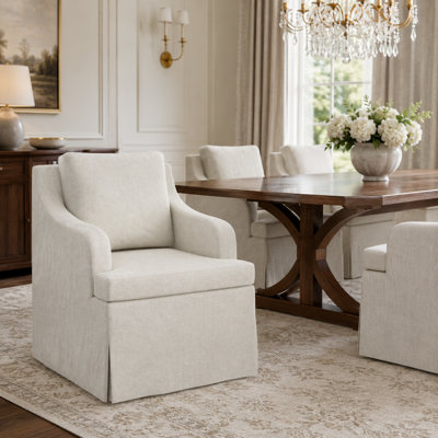 Cream Upholstered Skirted Dining Armchair with Curved Arms and Plush Back Cushion