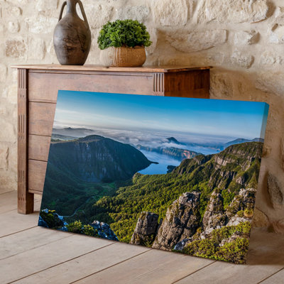 Canvas A Breathtaking Aerial View Of A Lush Green Valley Surrounded Wall Art By Towering Cliffs Showcasing A Vibrant Landscape Under A Canvas Wall Art