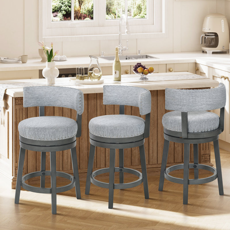 Tabouret de comptoir pivotant rembourré de 61 cm (24 po), pivotant à 360°, avec assise et dossier rembourrés, structure en bois massif, repose-pieds et garniture cloutée.