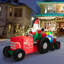 Père Noël conduisant un tracteur gonflable
