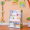 Teamson Kids Sunny Safari 3-Tier Front-Facing Wooden Bookshelf with Fabric Slings and Storage Cubbies for Playroom