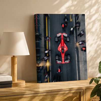 Canvas A Dynamic Overhead View Of A Vibrant Red Formula Car Wall Art Prominently Displayed In A Pit Stop Surrounded By A Team For Canvas Wall Art