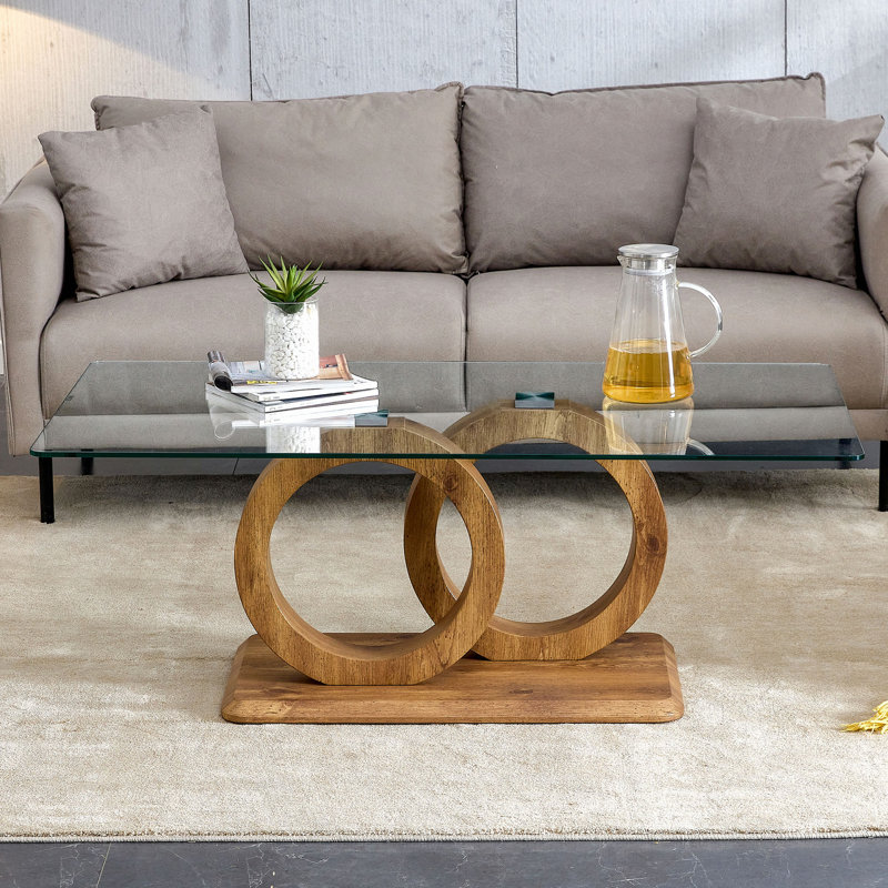 Une table basse rectangulaire moderne et tendance avec un plateau en verre trempé et des pieds en grain de bois. Convient au salon: 47,2 po x 25,4 po x 17,9 po