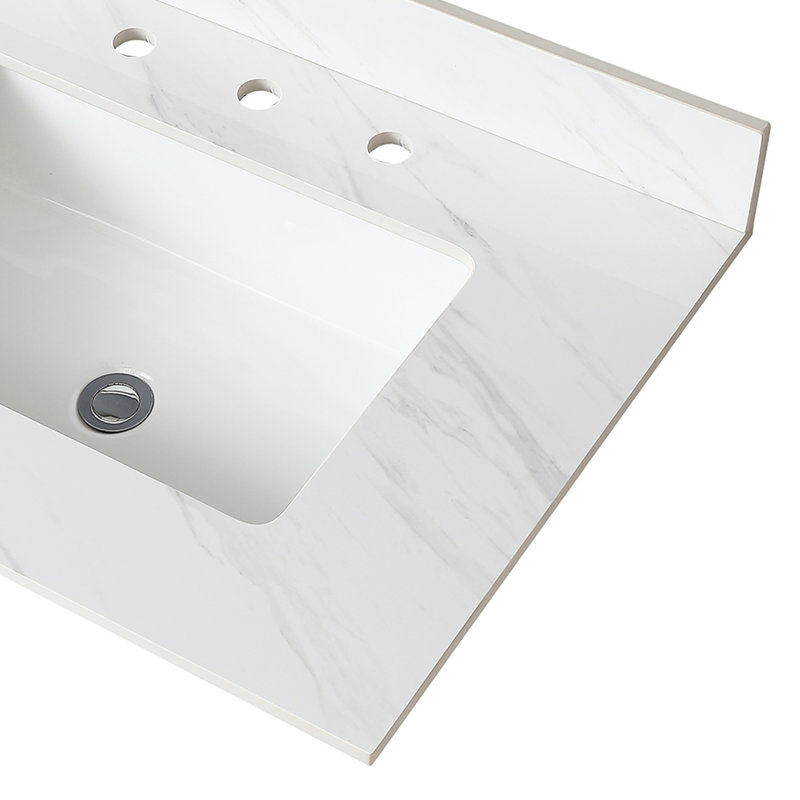 Le meuble-lavabo en pierre frittée blanche de 31 pouces, avec dosseret de 4 po et lavabo sous-comptoir rectangulaire, rehausse la fonctionnalité du comptoir en pierre et procure un look épuré