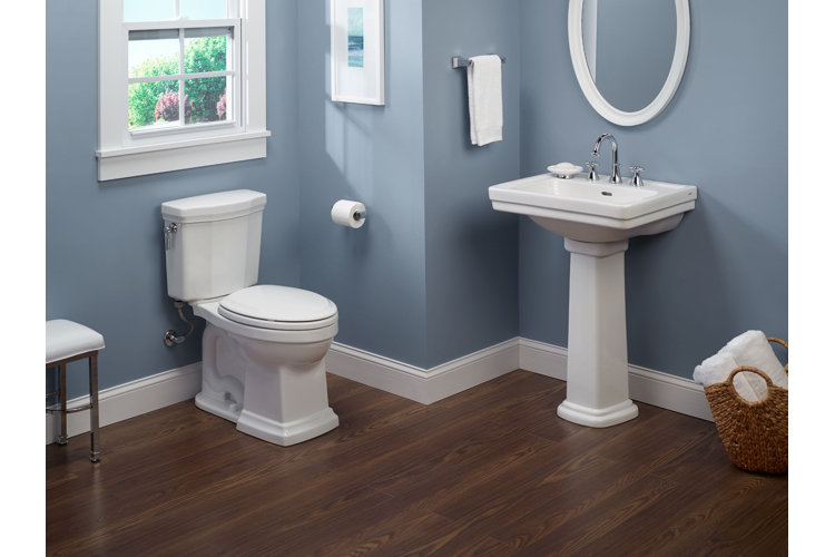 bathroom with blue walls, white toilet and white sink