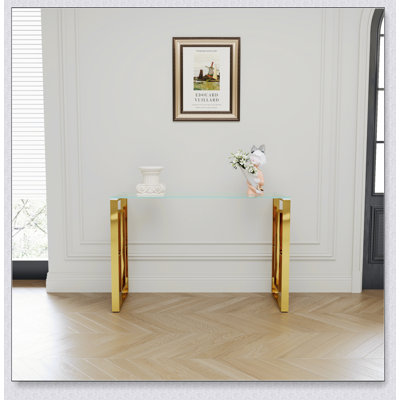 Élégante console en acier inoxydable et en verre, parfaite pour un décor moderne et un design peu encombrant.