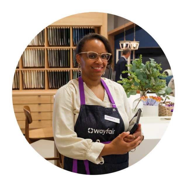 Xiomara A, Wayfair employee in apron holding tablet