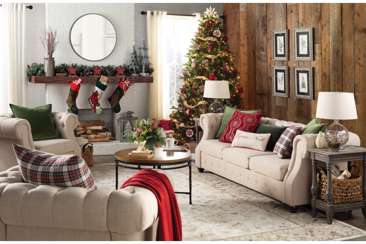 rustic living room with red holiday decorations and a wood accent wall