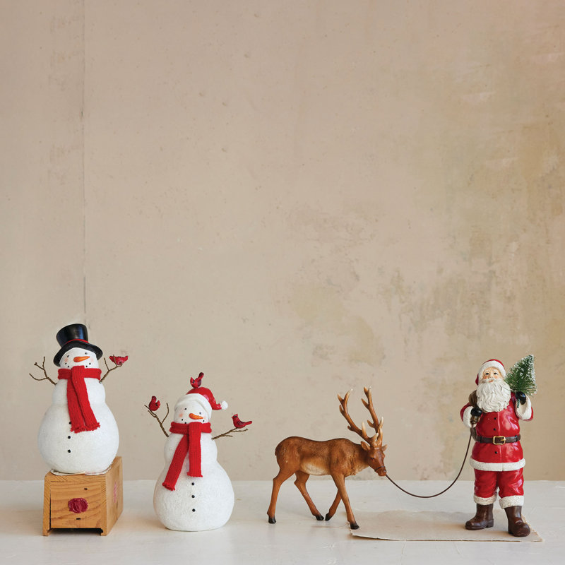 Résine père Noël menant un renne
