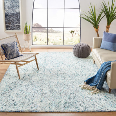 Tapis géométrique bleu / ivoire en laine touffetée à la main de la personne