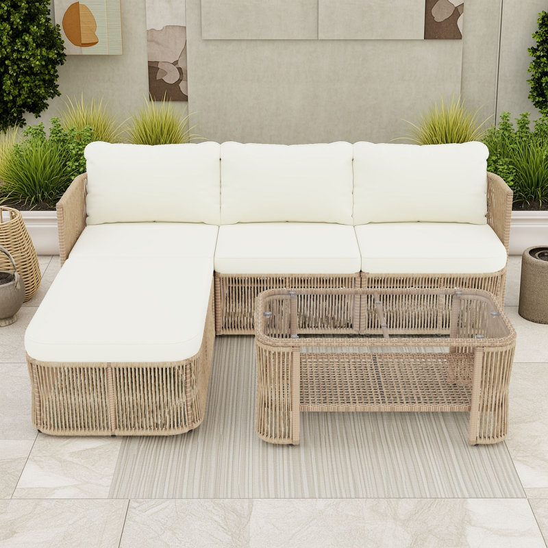 Ensemble de salon de jardin modulaire en rotin PE avec structure en fer antirouille, coussins, table basse en verre et étagère.