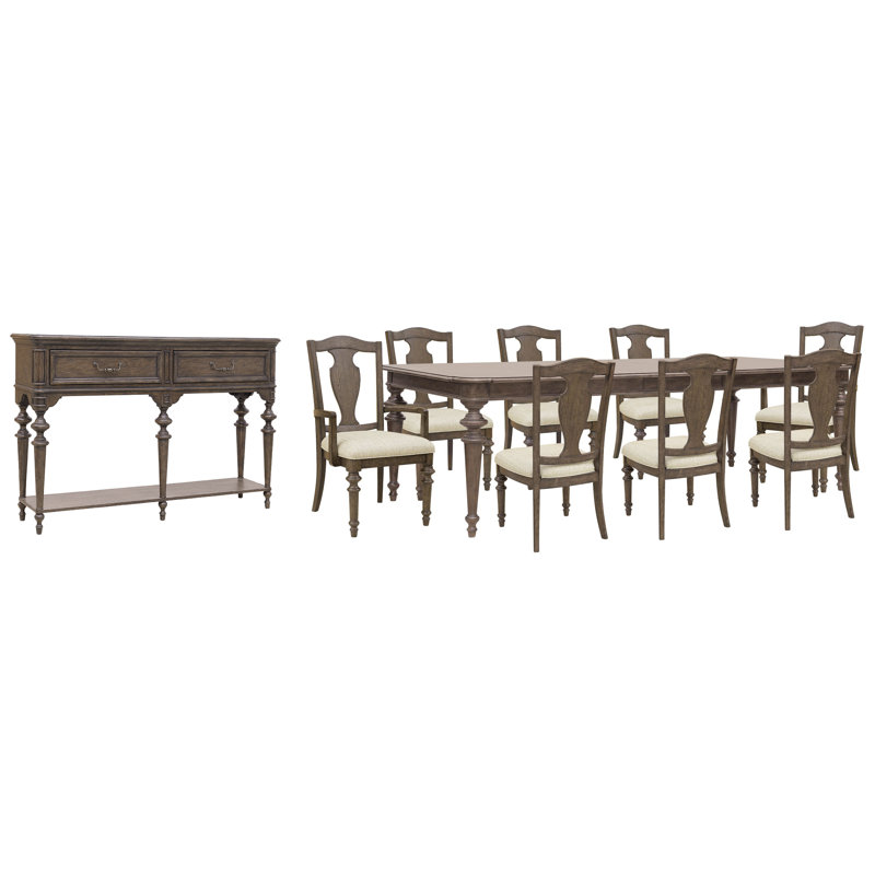 Table de salle à manger extensible avec 6 chaises à dossier en bois, 2 fauteuils et un buffet.
