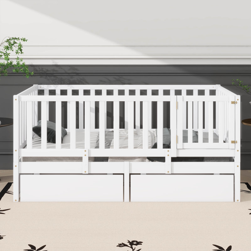 Lit de jour simple en bois avec garde-corps en forme de clôture pour la sécurité et deux tiroirs intégrés pratiques pour le rangement