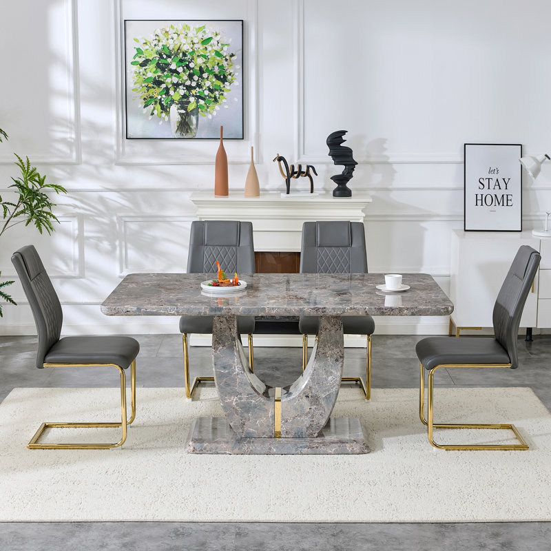 Ensemble de table de salle à manger moderne avec plateau en panneau de fibres à densité moyenne texturé gris et bordure dorée, base en forme de U, chaises en similicuir incluses