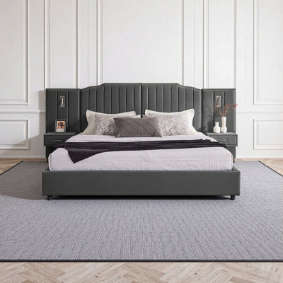 Très grand lit plateforme tapissier avec tables de chevet intégrées et lampes réglables