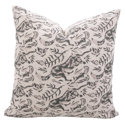 Square throw pillow in off-white linen with a dark gray botanical and animal block print pattern.