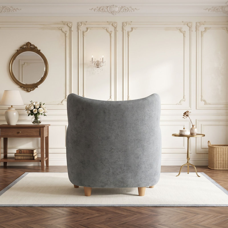 Fauteuil à oreilles avec pieds en bois massif et coussin à ressorts ensachés pour salon ou chambre