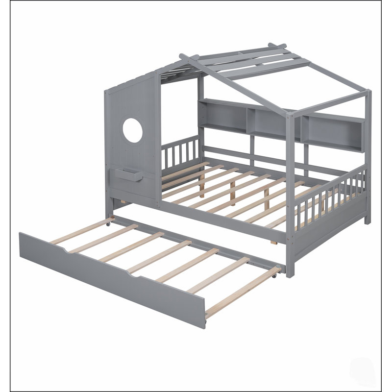 Lit cabane en bois pour enfants avec lit gigogne et étagères de rangement, idéal pour les chambres d'enfants et les jeux créatifs.