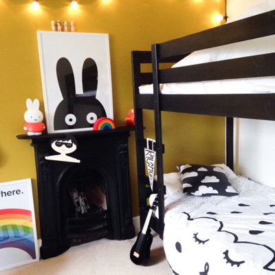 closeup of child-sized wooden bunk beds, graphic prints, guitar and miffy