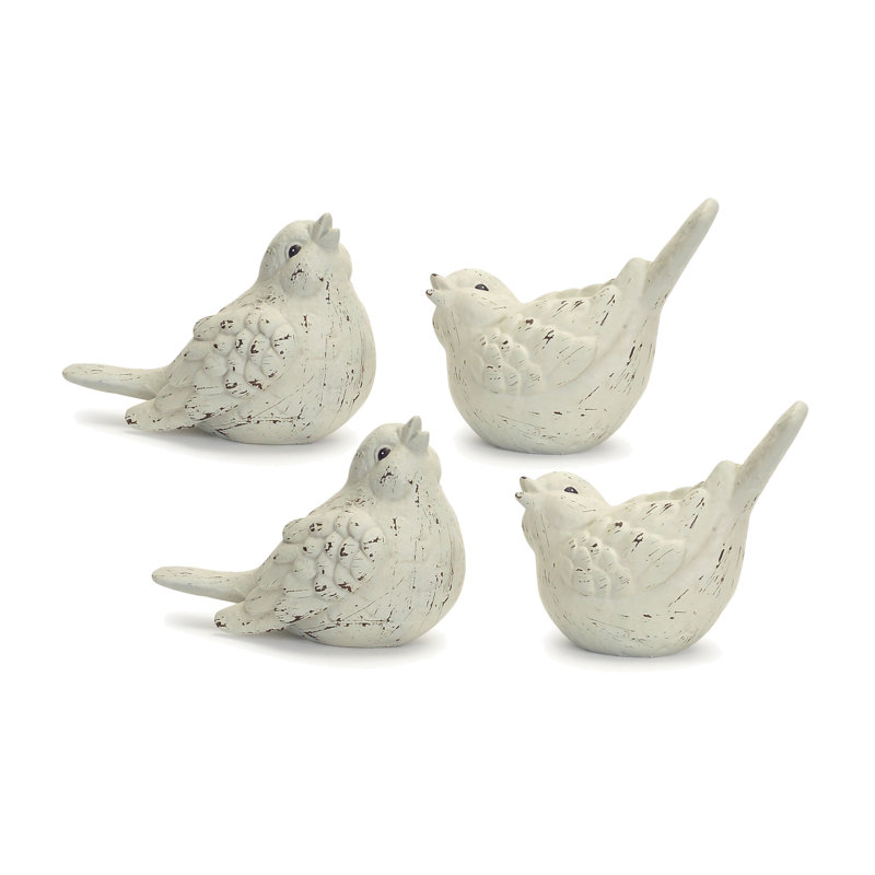 Ensemble de quatre figurines d'oiseaux en céramique ivoire