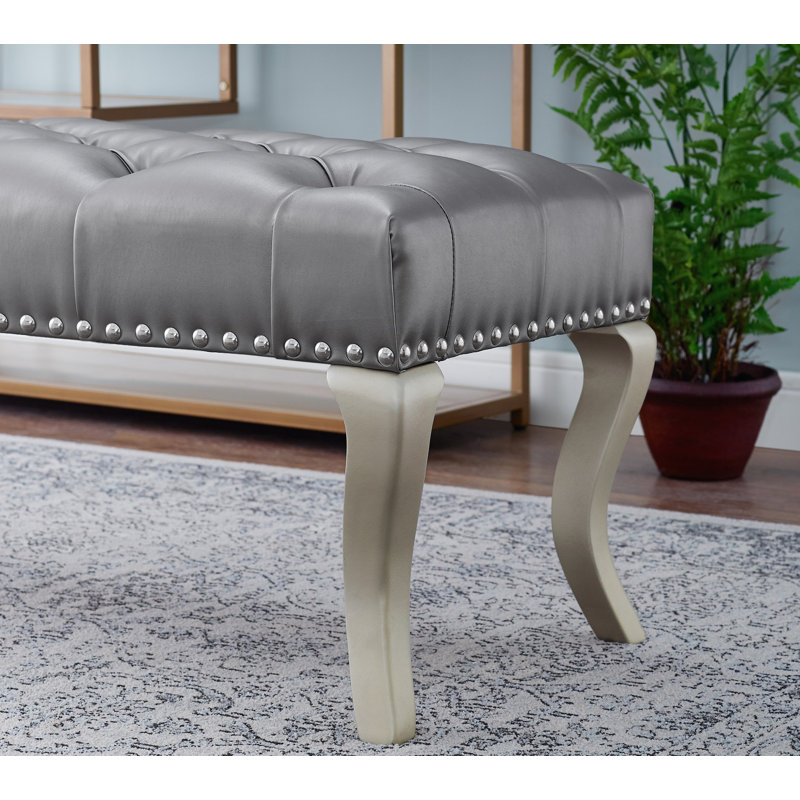 Banc capitonné en tissu avec garniture cloutée