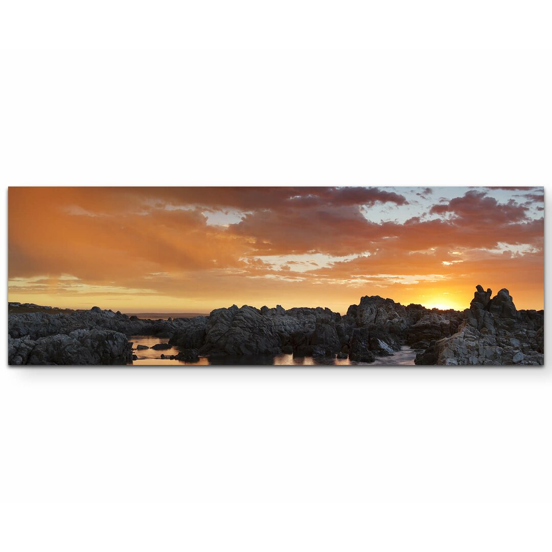 Leinwandbild Sonnenuntergang nach einem Gewitter am Meer