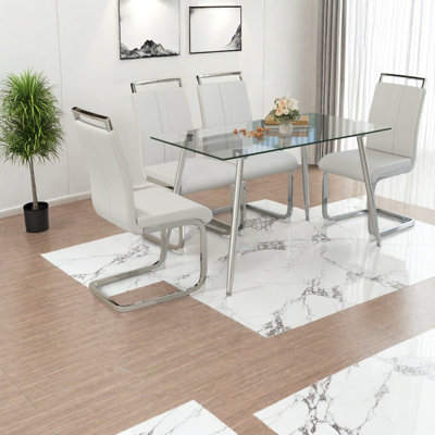 Ensemble de table de salle à manger spacieux en verre trempé de style moderne avec des pieds argentés pour la cuisine