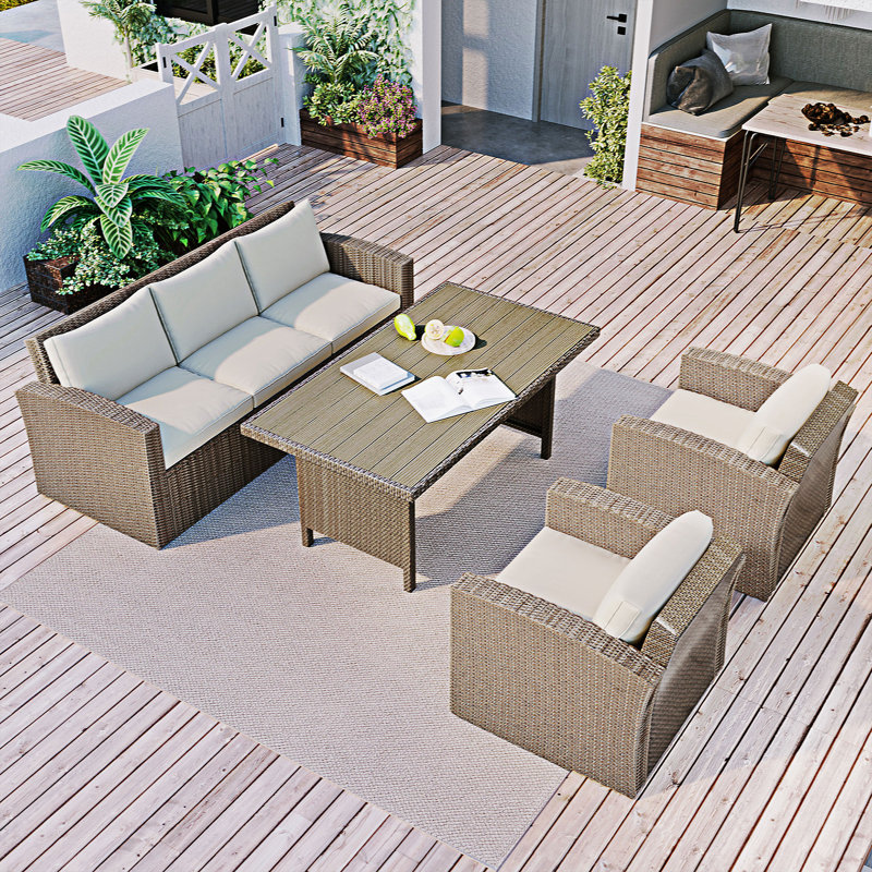 Evered 5 - Person Wicker Patio Dining Set with Rectangular Table , Cushions Included