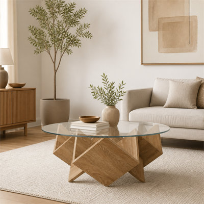 Table basse ronde de 35,5 pouces au fini naturel avec plateau en verre et base géométrique artistique avec tablette de rangement.