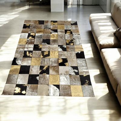 Tapis en peau de vache beige, noir et doré