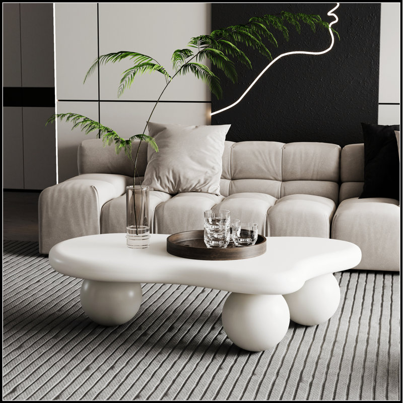 La table basse de 40 pouces en forme de nuage avec 3 pieds sphériques pour le salon, blanc crème, ajoute un charme et une fonctionnalité uniques