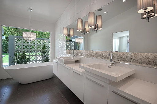 modern bathroom with large floor and wall tiles and a backsplash of tiny square tiles