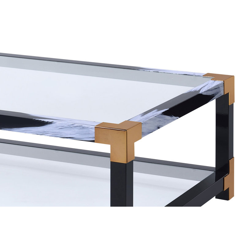 Élégante table basse à pieds en métal avec plateau en verre transparent et structure de rangement ouverte moderne