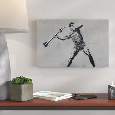 Javelin Thrower by Banksy - Wrapped Canvas Print
