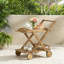 Chariot-bar RIVIERA avec roues mobiles et fabrication en bois d'acacia naturel pour un divertissement élégant et un rangement flexible.