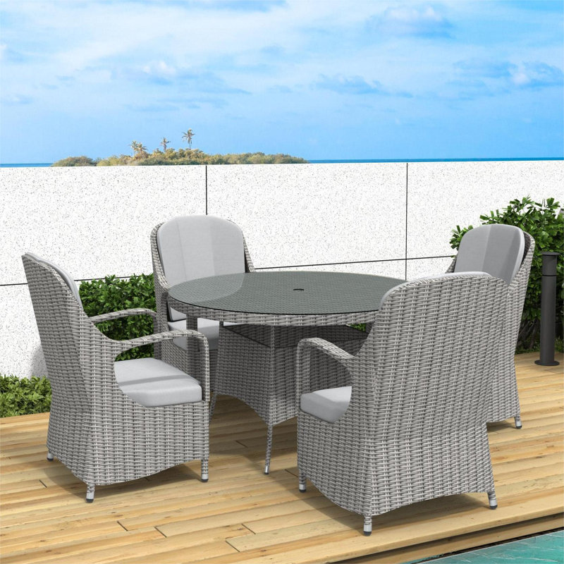 Dustinjames 6 - Person Wicker Patio Dining Set with Round Table , Cushions Included